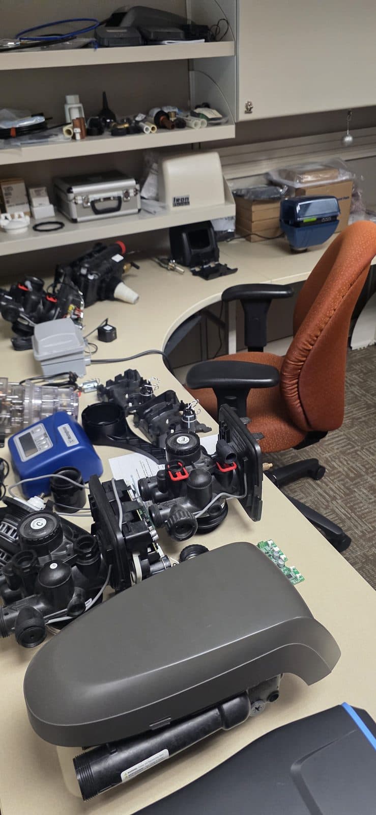 Aquonyx technical support desk with control valves and components in reach for live phone troubleshooting